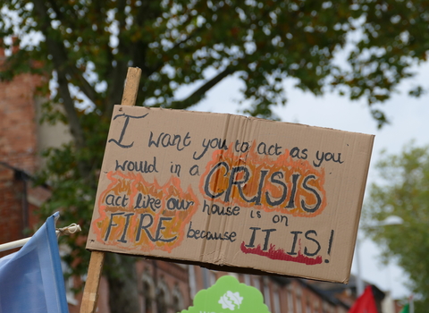 A poster at a climate march reads: 