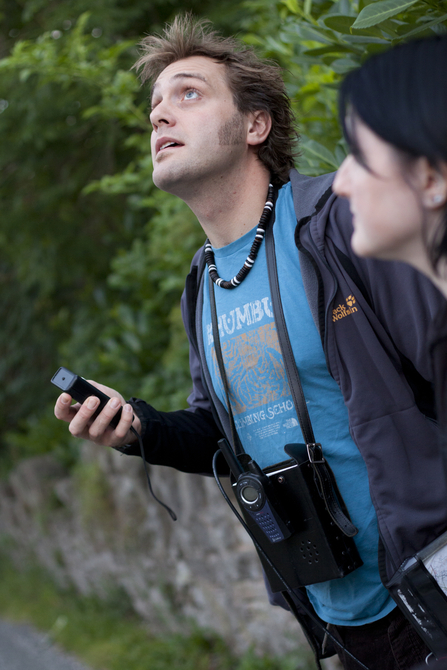 A person using a bat surveying device