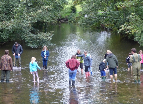 children and adults river dipping 